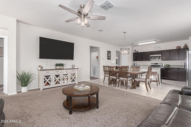 living room with ceiling fan and light tile patterned flooring