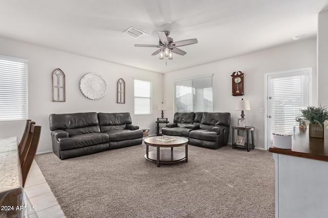 living room featuring light colored carpet and ceiling fan