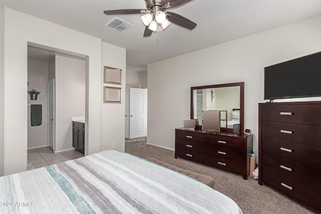 carpeted bedroom featuring ensuite bath and ceiling fan