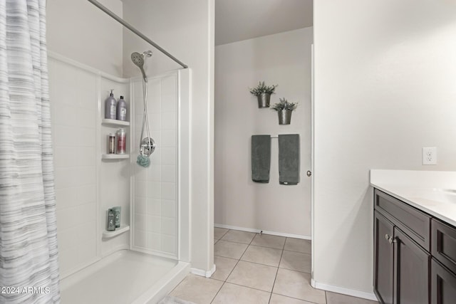 bathroom featuring a shower with shower curtain, vanity, and tile patterned floors