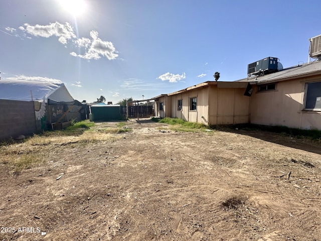view of yard with cooling unit and fence