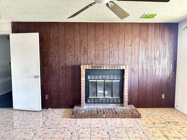room details featuring wood walls, a brick fireplace, a textured ceiling, and a ceiling fan