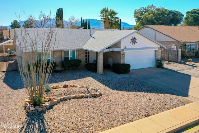 single story home featuring a mountain view and a garage