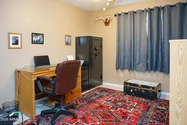 tiled home office with a textured ceiling