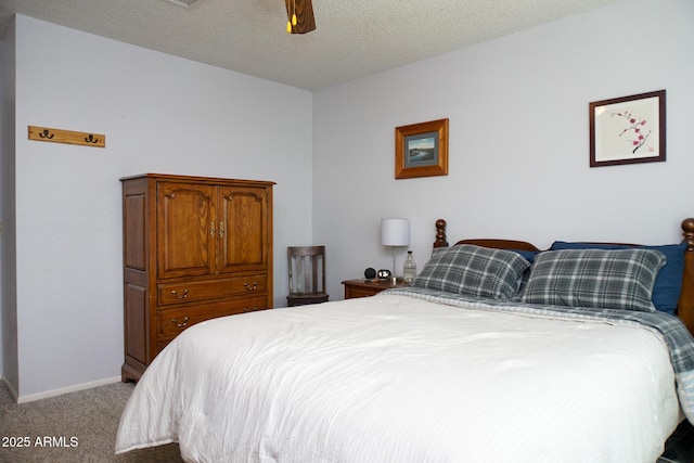 bedroom with ceiling fan, light colored carpet, and a textured ceiling