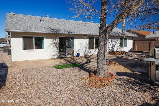 rear view of property with a patio area and central air condition unit