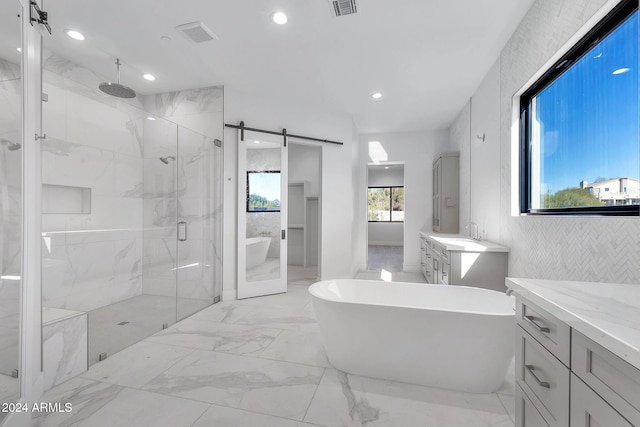 bathroom with vanity and separate shower and tub