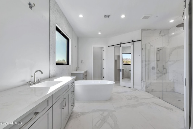 bathroom featuring a healthy amount of sunlight, shower with separate bathtub, and vanity