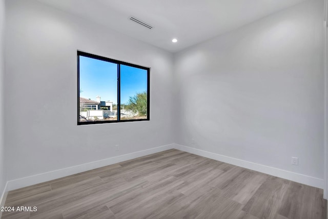 spare room featuring light hardwood / wood-style flooring