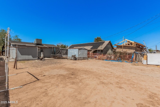 3913 W Sherman St, Phoenix, AZ 85009 - view of yard with central AC and a trampoline