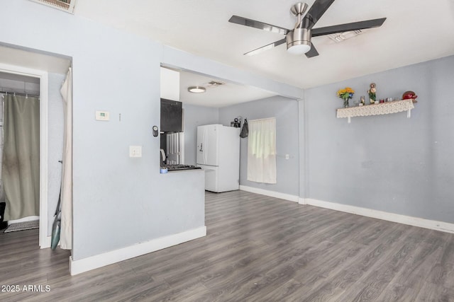 3913 W Sherman St, Phoenix, AZ 85009 - unfurnished living room featuring a ceiling fan, baseboards, and wood finished floors
