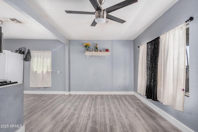 3913 W Sherman St, Phoenix, AZ 85009 - unfurnished living room with ceiling fan, wood finished floors, and baseboards