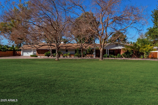 ranch-style house with a front yard and fence