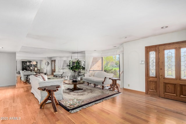 living room with light wood-style floors and baseboards