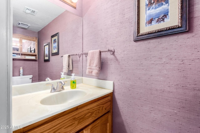 bathroom featuring vanity and toilet