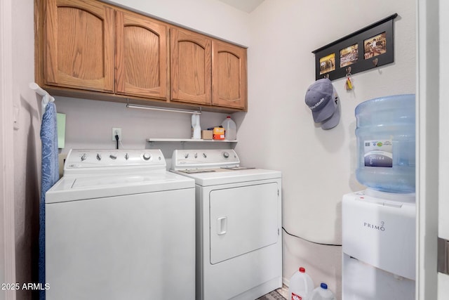 washroom with cabinets and washer and dryer