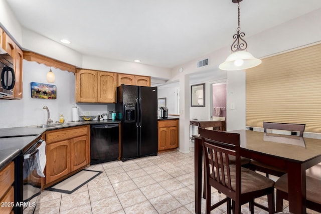 kitchen featuring hanging light fixtures, sink, light tile patterned floors, and black appliances