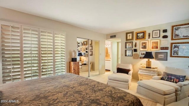 carpeted bedroom featuring ensuite bathroom and a closet