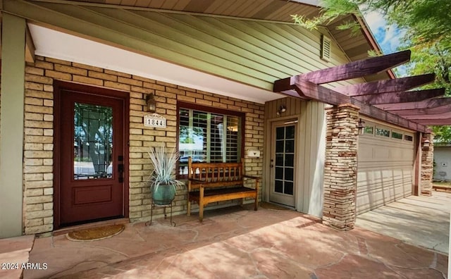 doorway to property with a garage