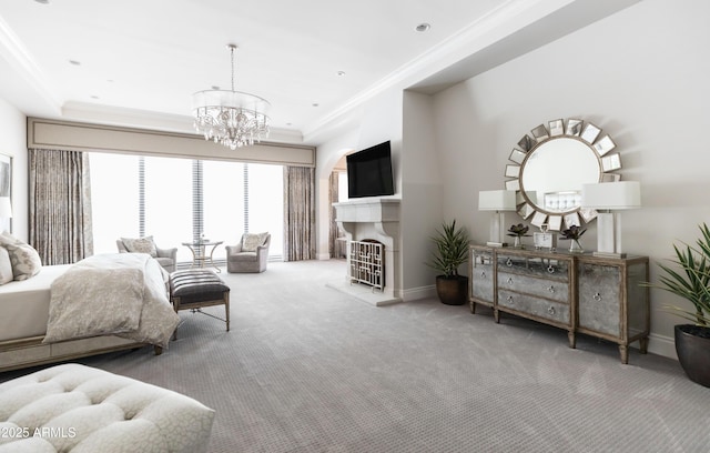 carpeted bedroom featuring baseboards, recessed lighting, a fireplace with raised hearth, crown molding, and a notable chandelier