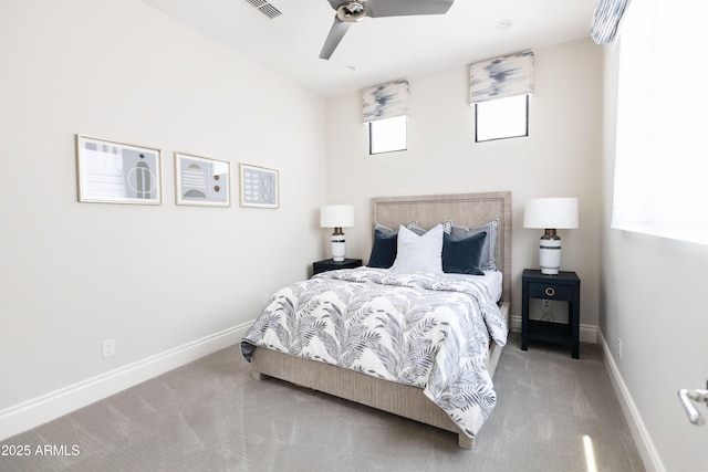 carpeted bedroom with ceiling fan and baseboards