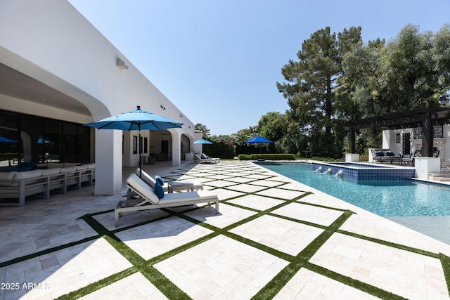 view of swimming pool with a patio area, a pool with connected hot tub, and a pergola