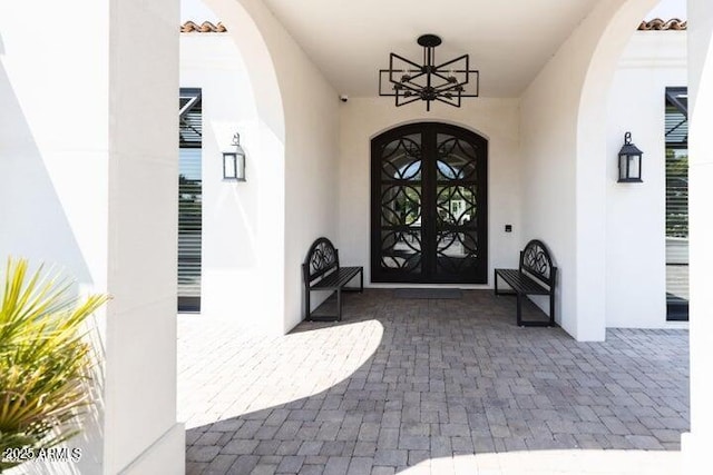 property entrance with french doors and stucco siding