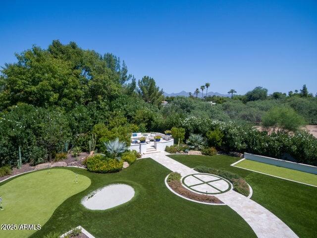 surrounding community featuring a lawn and a patio area