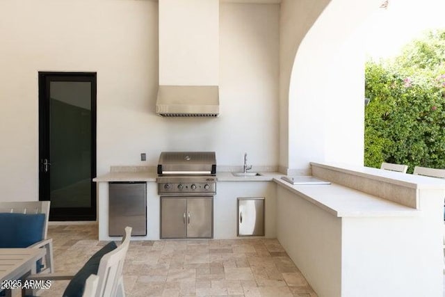 view of patio / terrace featuring a sink, area for grilling, and an outdoor kitchen