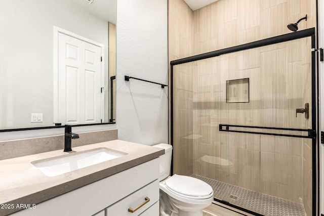 18139 W Oregon Ct, Litchfield Park, AZ 85340 - bathroom featuring a stall shower, vanity, and toilet