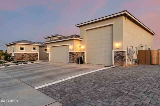 18139 W Oregon Ct, Litchfield Park, AZ 85340 - view of front facade with stone siding, stucco siding, and an attached garage