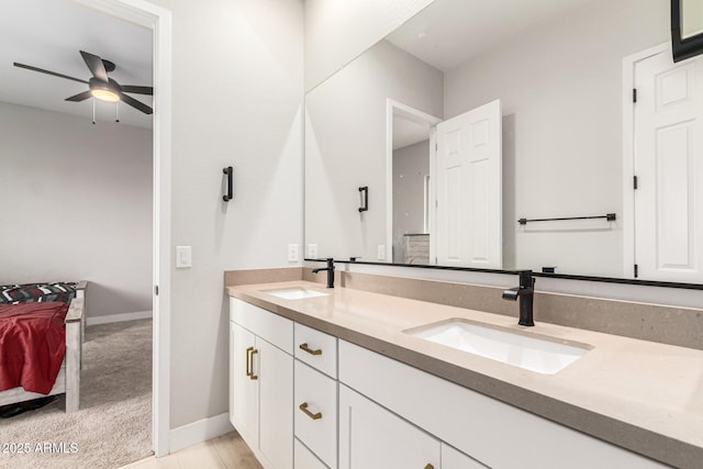 18139 W Oregon Ct, Litchfield Park, AZ 85340 - ensuite bathroom featuring double vanity, baseboards, and a ceiling fan
