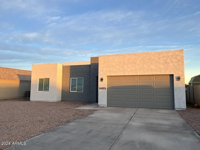 pueblo-style home with a garage