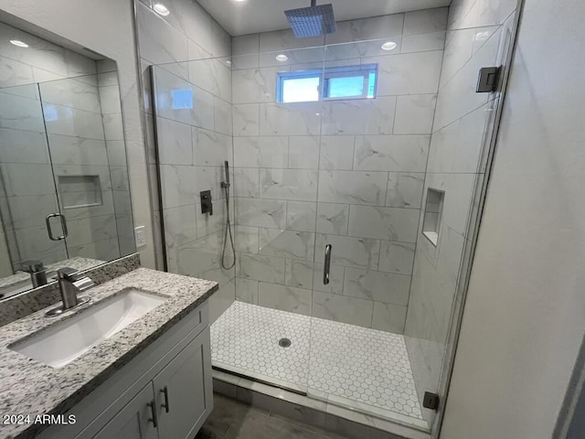 bathroom with walk in shower and vanity