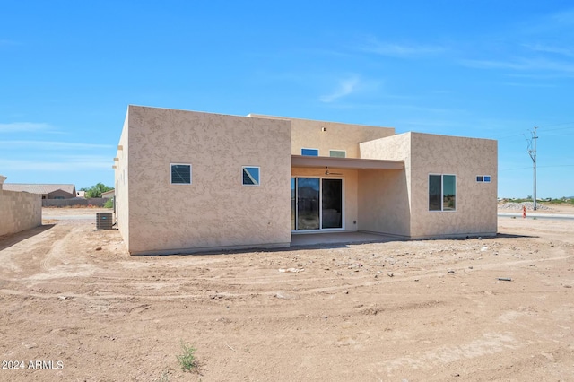 back of house featuring central AC unit