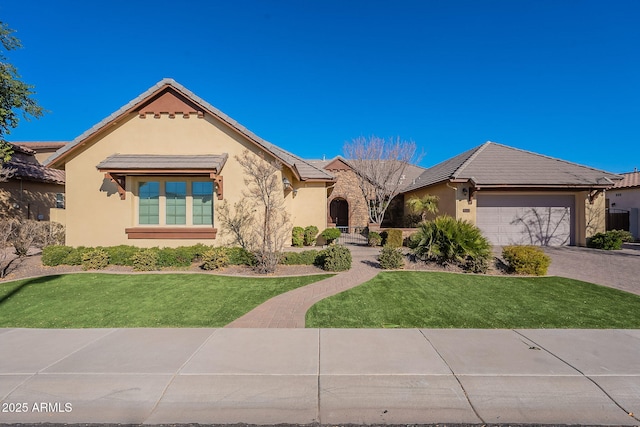 view of front of home featuring a garage and a front yard