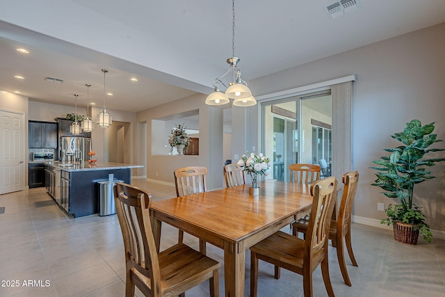 dining space featuring sink and light tile patterned floors