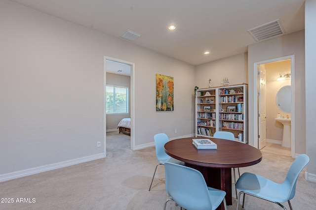 dining space with light colored carpet