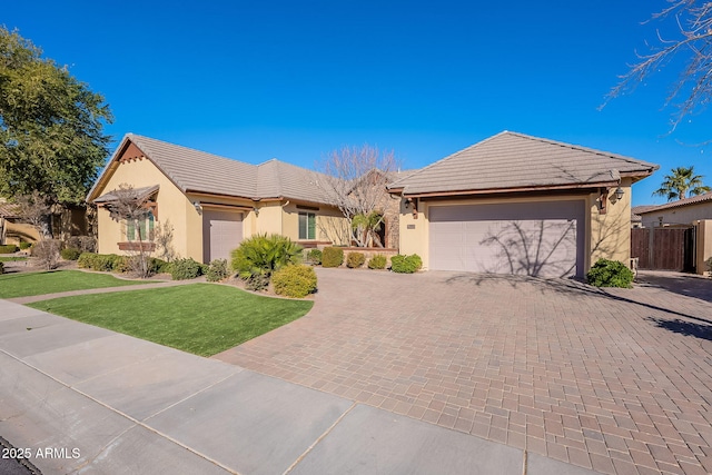 ranch-style home featuring a garage and a front yard