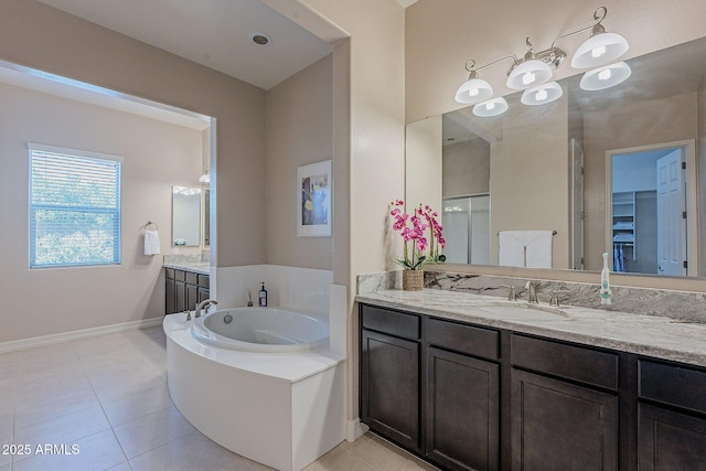 bathroom featuring vanity, a bathtub, and tile patterned floors