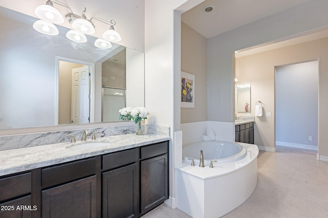 bathroom featuring tile patterned floors, a bathtub, and vanity