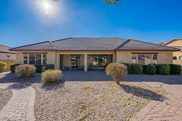 rear view of property featuring a patio