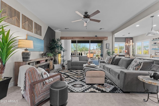 living room with ceiling fan with notable chandelier