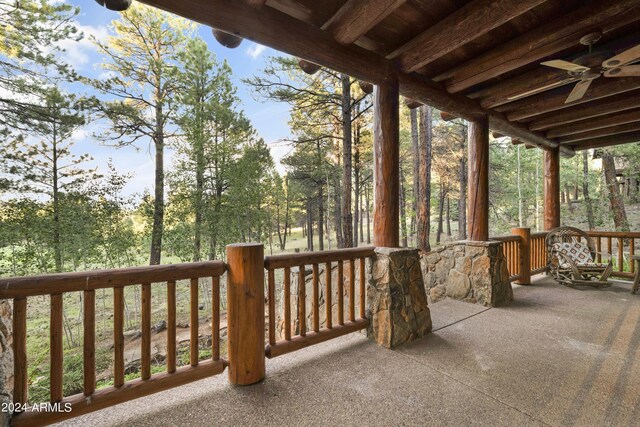 wooden deck featuring ceiling fan