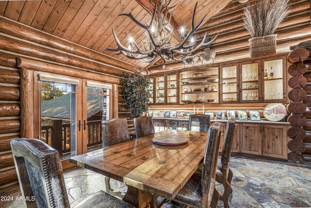 dining space with a chandelier, log walls, and wooden ceiling