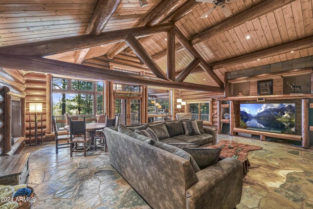 living room with wood ceiling, a healthy amount of sunlight, ceiling fan, and beam ceiling