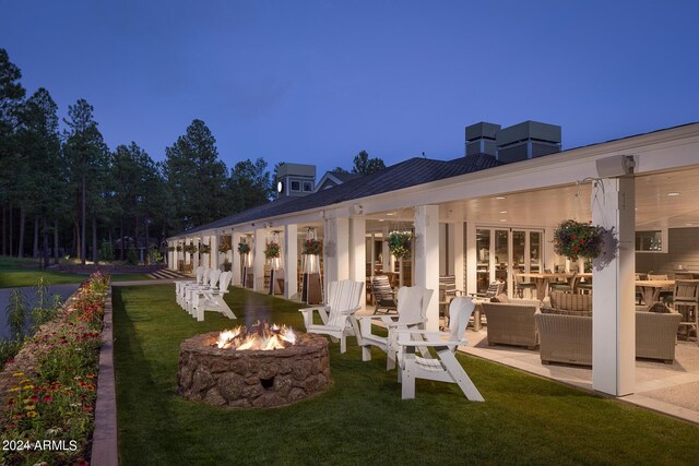 exterior space featuring an outdoor living space with a fire pit, a yard, and a patio area