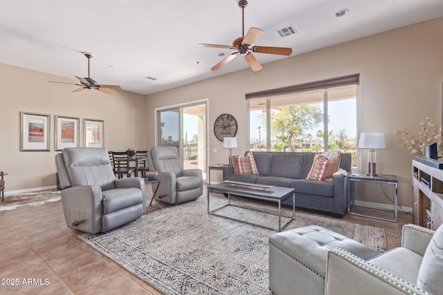 living area with visible vents, ceiling fan, baseboards, and tile patterned floors