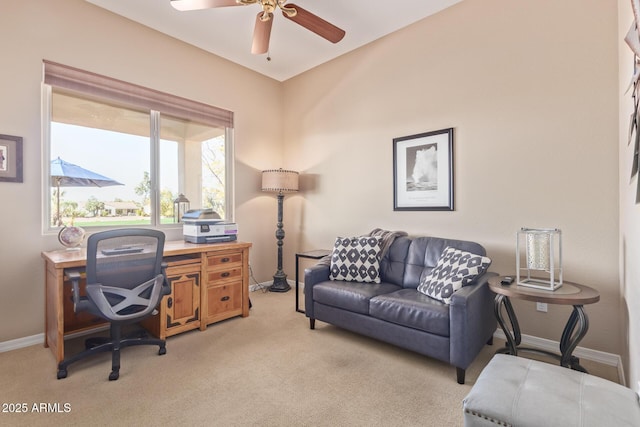 home office with baseboards, ceiling fan, and light colored carpet