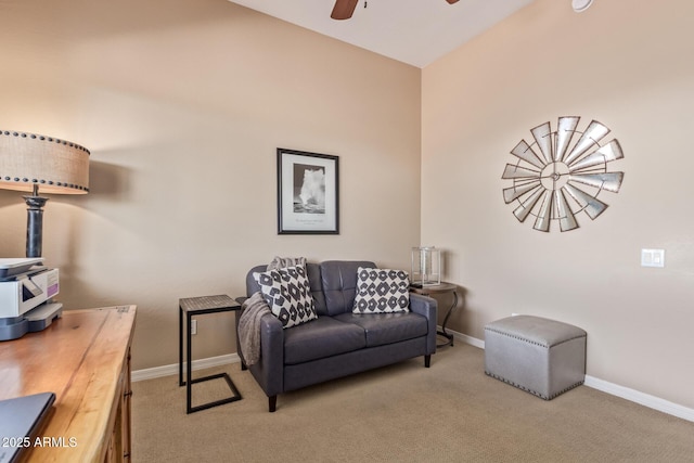 living room with light colored carpet, ceiling fan, and baseboards